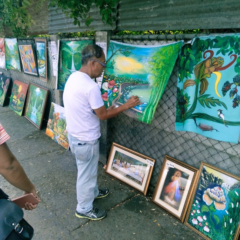 Local Filipino artist selling his artwork on the streets. Photo Credit: filipinotimes.net